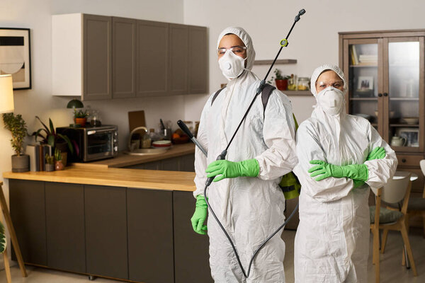 Portrait of cleaning workers disinfecting apartment in team