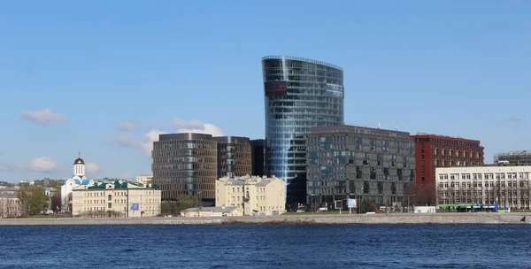 New houses on the river bank. Modern apartment buildings in the residential area on the Neva River.
