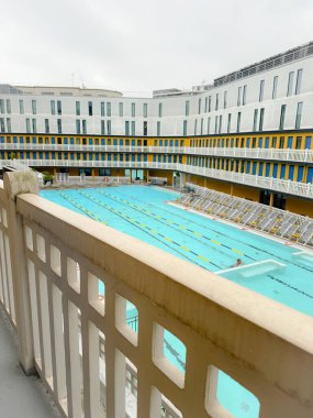 France, Paris, November 17, 2024, View from the balcony of the famous piscine molitor in paris, with a swimmer training in the pool clipart