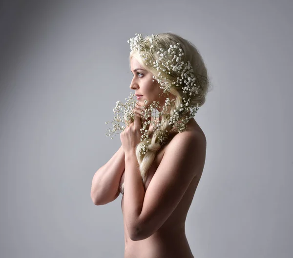 stock image Close up portrait of beautiful women with long blonde hair, wearing white fantasy princess ball gown, holding pretty baby breath flowers,  isolated on white studio background