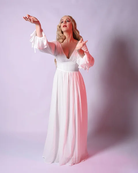 stock image Full length portrait  of blonde woman  wearing white historical bridal gown fantasy costume dress.    Standing pose, facing forwards with gestural arms reaching out , isolated on studio background.