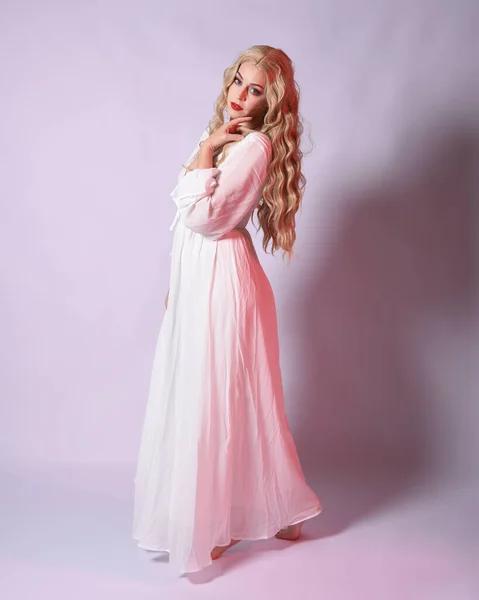 Full length portrait  of blonde woman  wearing white historical bridal gown fantasy costume dress.    Standing pose, facing forwards with gestural arms reaching out , isolated on studio background.
