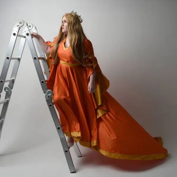 Full length portrait of plus sized woman blonde hair, wearing historical medieval fantasy gown, golden crown of royal queen. climbing ladder as is on castle wall, isolated studio background.