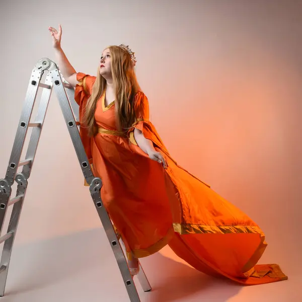 Full length portrait of plus sized woman blonde hair, wearing historical medieval fantasy gown, golden crown of royal queen. climbing ladder as is on castle wall, isolated studio background.