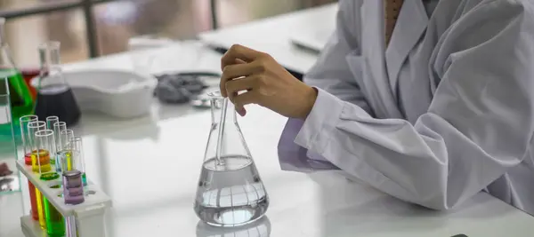 Young female scientist testing tube chemical ingredient to conduct research in laboratory,test sample antibiotics and future food use in medical development for people