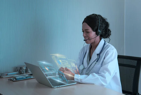 Black female doctor,specialist sitting desk and headset, consulting health care and disease counseling to patients and public, service telemedicine online,online communication from hospital to home.