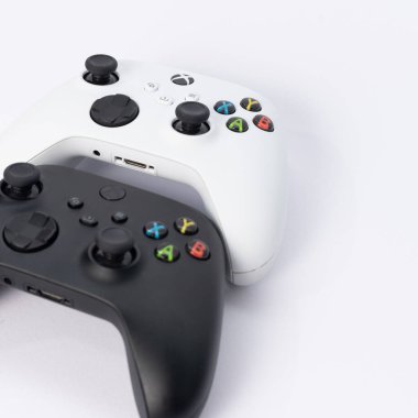 Ivano-Frankivsk, Ukraine August 14, 2022: x series gamepad on a white background, black and white gamepads for games.