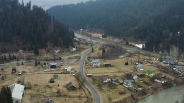 Ukrayna 'daki bir Karpatlar köyünün en üst görüntüsü, ilkbaharın başlarında dağlarda, 4k drone videosu.