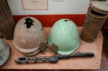 Kyiv, Ukraine, July 1, 2022: Two old Soviet helmets in an abandoned building, helmets with bullet holes.