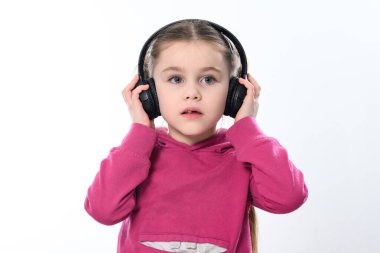 A child with headphones on a white background, a cheerful and beautiful girl with headphones, copy space on a white background.
