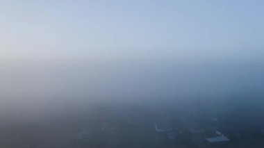 drone flight up from the village between the clouds to the clear sky, on the horizon clear sky and high mountains, picturesque morning landscapes of Ukraine.