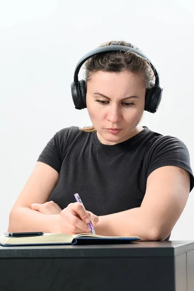 Zajęta Młoda Kobieta Słuchawkach Pracująca Laptopie Wykonująca Rozmowy Wideo Notatki — Zdjęcie stockowe