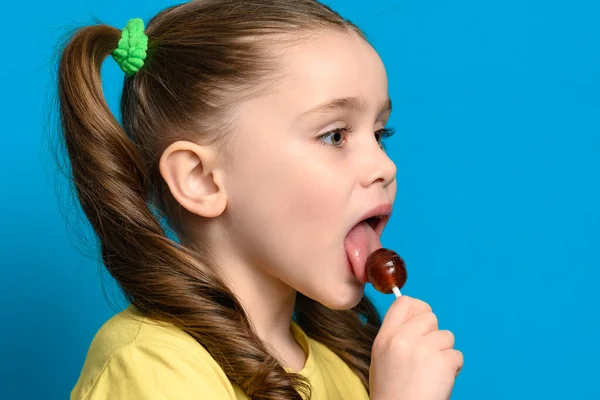 Modrém Pozadí Dívka Olizuje Kulaté Lízátko Zblízka Caries Špatné Jídlo — Stock fotografie