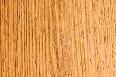 Duvarın arka planı turuncu boyayla boyanmış eski tahtaların dokusu.