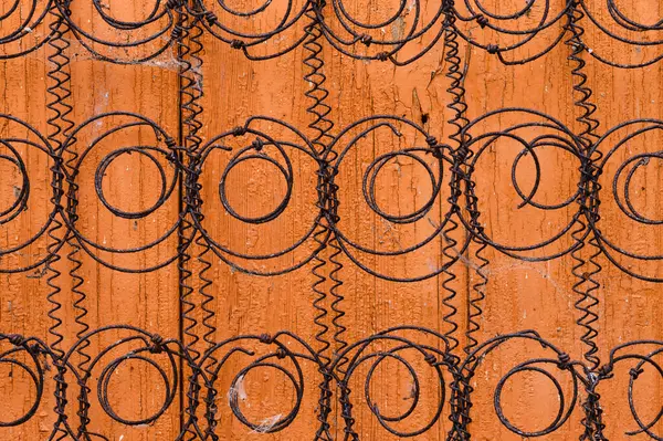 Old spiral springs from a sofa mattress on an orange background