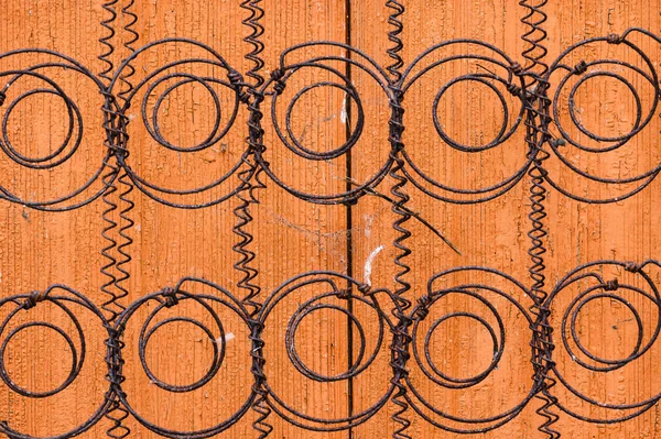 Old spiral springs from a sofa mattress on an orange background