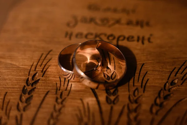 Wedding rings for weddings and marriages on a wooden surface, gold rings for brides.