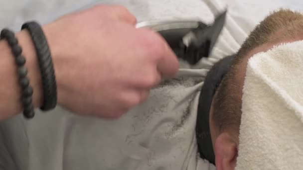 クリッパーと床屋で 紳士の髭を切る クライアント4Kビデオのマスターによる側面からのひげの長さを短縮する — ストック動画