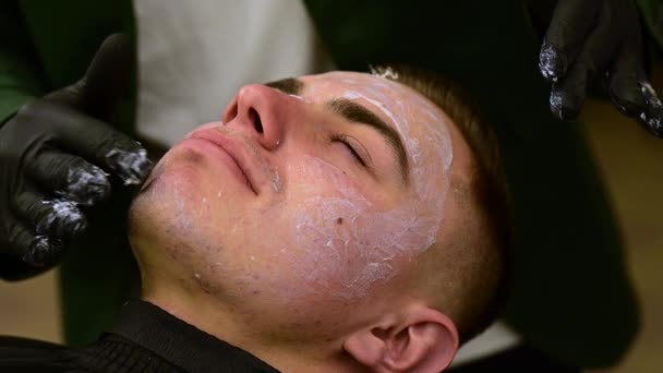 Barber Black Gloves Applies Moisturizing White Cream Clients Face Beautician — Stock Video