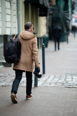 Kalabalık caddelerin ortasında, elinde kamerayla gezen bir fotoğrafçı potansiyel bir öğleden sonra ilham verici kentsel anları yakalamaya hazır..