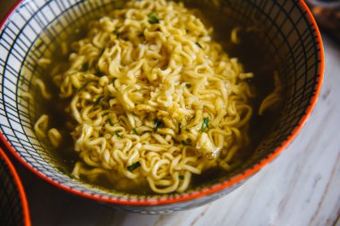 Instant pasta, Japanese and Chinese noodles. Ramen type soup in a plate with chopsticks, junk fast food. Quick-cooking pasta