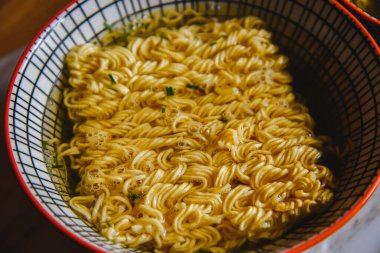 Instant pasta, Japanese and Chinese noodles. Ramen type soup in a plate with chopsticks, junk fast food. Quick-cooking pasta