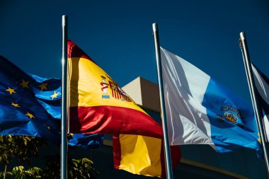 Los Cristianos, Tenerife Spain. 12/18/2022 Flags in the sun, the flag of Spain, the European Union, the flag of Tenerife and the Flag of Canary Islands are a Spanish Atlantic Ocean.