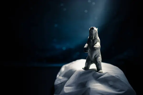 Polar bear figurine in climate change, global warming still life background with copy space.