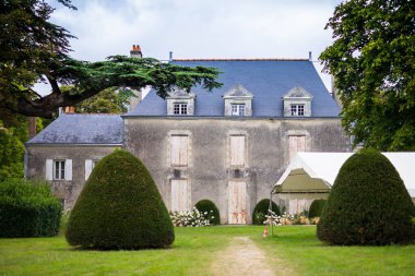 View from the park of Chateau de la Mevelliere in Bouaye, Atlantic Loire, France. clipart