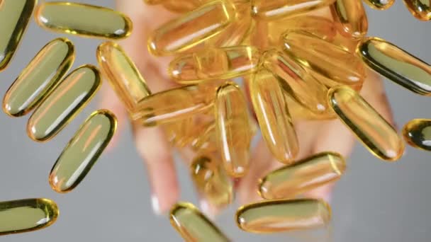 Fish Oil Capsules Spill Out Women Palms Flat Transparent Table — Stock Video