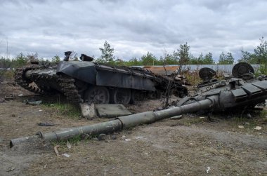 IRPIN, UKRAINE - Broken tanks, combat vehicles and other burnt military equipment of the Russian invaders in Irpin,The russian tank burned by the Ukrainian army. Kiev region clipart