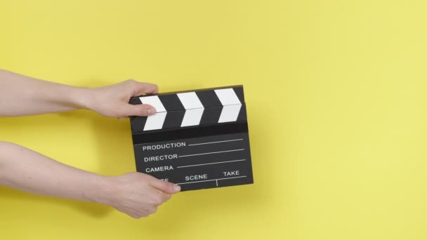 Film Clapperboard Hands Yellow Background — Stock Video