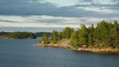 İsveç. Idyllic Stockholm takımadaları. Rocky Adası 'ndaki İsveç Ahşap Kulübesi. Geleneksel kırmızı yazlık evler. Stockholm Takımadaları. Sahilde kulübeler ve saunalar