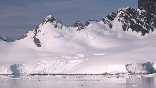有雪山 冰川和冰山的南极景观 南极洲结冰海岸的景观 美丽的蓝色冰山 镜像反射漂浮在海洋中 严酷大陆上的冰川 — 图库视频影像