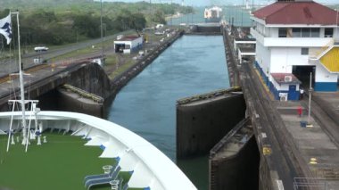 Panama Canal, Panama, 20 August 2019: A large ship passes through the lock system of the Panama Canal. Engineering industrial. Panama Canal lock gates closing fast motion.