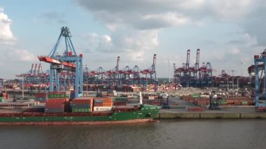 HAMBURG, GERMANY-JUNE, 2023: Gantry cranes in the seaport of Hamburg. Huge harbour cranes. Hamburg port with cranes and cargo ship. Container terminal. Transport industry. Logistics technologies. 4K