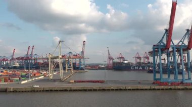 HAMBURG, GERMANY-JUNE, 2023: Gantry cranes in the seaport of Hamburg. Huge harbour cranes. Hamburg port with cranes and cargo ship. Container terminal. Transport industry. Logistics technologies. 4K