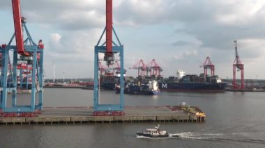 HAMBURG, GERMANY-JUNE, 2023: Gantry cranes in the seaport of Hamburg. Huge harbour cranes. Hamburg port with cranes and cargo ship. Container terminal. Transport industry. Logistics technologies. 4K