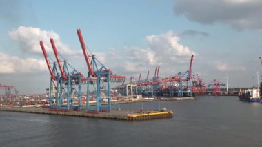 HAMBURG, GERMANY-JUNE, 2023: Gantry cranes in the seaport of Hamburg. Huge harbour cranes. Hamburg port with cranes and cargo ship. Container terminal. Transport industry. Logistics technologies. 4K