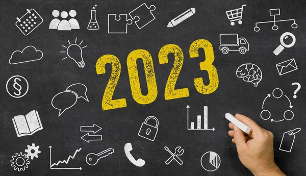 stock image  2023 written on a blackboard with icons 