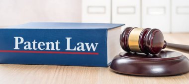 A law book with a gavel - Patent law clipart