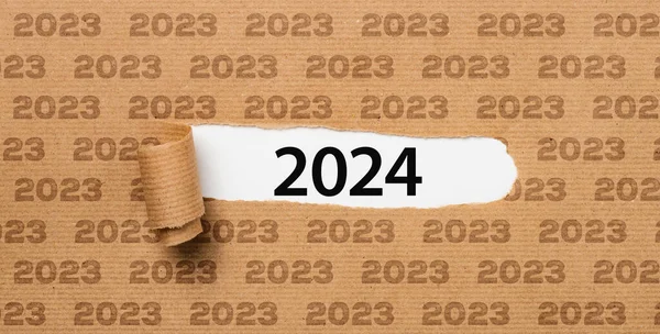 stock image Torn paper revealing the number 2024