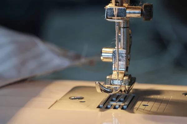 stock image Close up shot of sewing machine steel foot with needle and thread, selective focus