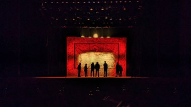 People silhouettes on the illuminated theatre stage clipart