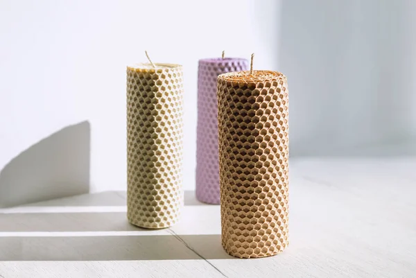 stock image Candles made of beeswax on white table in sunny day.