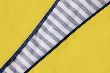 Yellow and grey strippedbackground with zipper.