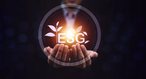 stock image ESG visual screen on hand.ESG environmental social governance business strategy investing concept.