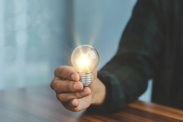 stock image Man hand holding light bulb. idea concept with innovation and inspiration