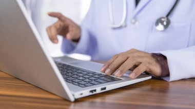 Doktorlar modern teknolojiyi kullanarak tedavi verilerini hastanenin veri depolama sistemine kaydetmek için bilgisayar kullanıyorlar..