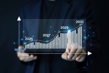 İşadamı, finansal büyümeyi analiz etmek ve gelecekteki pazar eğilimlerini tahmin etmek için dijital grafiklerle yapay zeka teknolojisi kullanıyor.